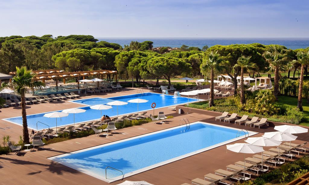 Resort pools surrounded by pine trees near the Algarve coast